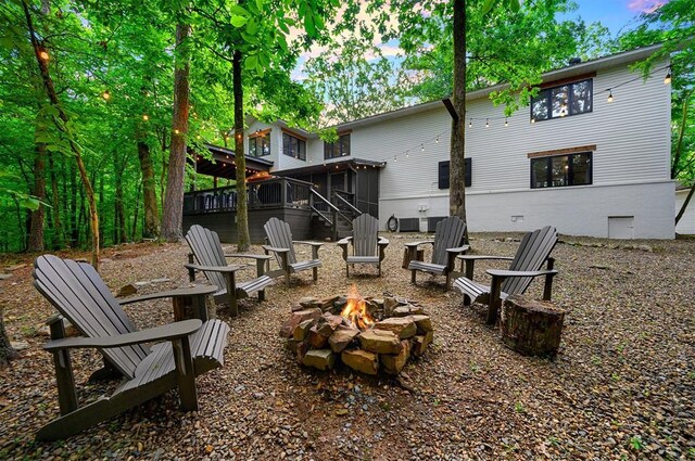 47 White Pine Rd, Broken Bow, OK 74728 - rear view of property featuring an outdoor fire pit, a sunroom, stairs, a wooden deck, and crawl space
