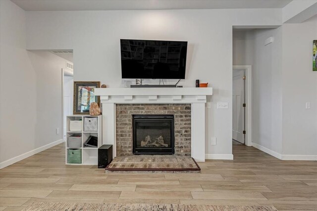 12905 NW 4th St, Yukon, OK 73099 - living area with wood finished floors, a fireplace, and baseboards