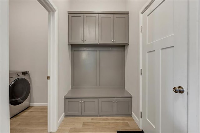 12905 NW 4th St, Yukon, OK 73099 - laundry area with washer / dryer, light wood finished floors, baseboards, and cabinet space