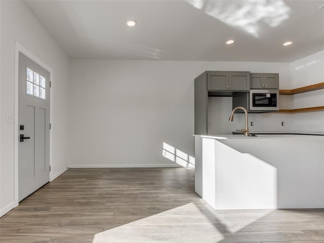 2812 Shoreridge Ave Unit 2814, Norman, OK 73072 - kitchen featuring built in microwave, gray cabinets, light wood-type flooring, a sink, and recessed lighting