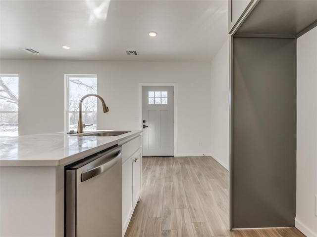 2812 Shoreridge Ave Unit 2814, Norman, OK 73072 - kitchen featuring stainless steel dishwasher, a sink, white cabinetry, light wood-type flooring, and an island with sink