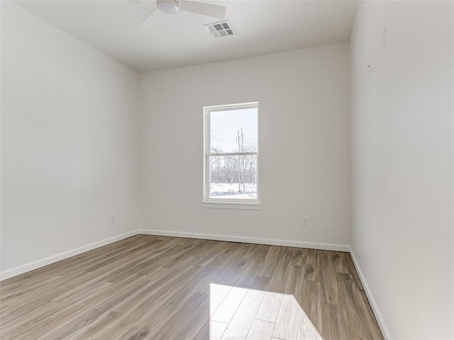 2812 Shoreridge Ave Unit 2814, Norman, OK 73072 - spare room featuring wood finished floors, baseboards, and a ceiling fan
