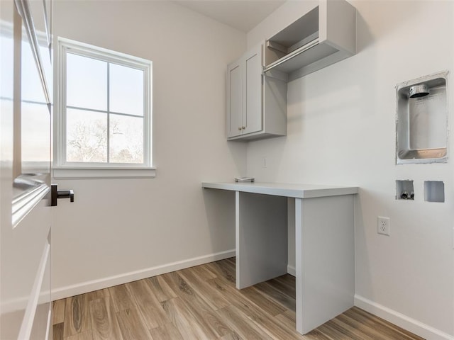 2812 Shoreridge Ave Unit 2814, Norman, OK 73072 - laundry room featuring cabinet space, light wood-type flooring, baseboards, and washer hookup
