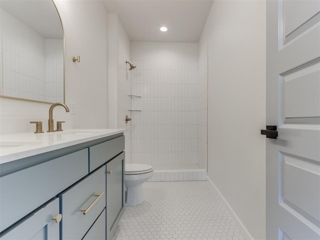 2812 Shoreridge Ave Unit 2814, Norman, OK 73072 - full bathroom featuring double vanity, toilet, a tile shower, baseboards, and tile patterned floors