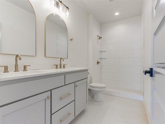 2812 Shoreridge Ave Unit 2814, Norman, OK 73072 - bathroom featuring double vanity, toilet, a tile shower, recessed lighting, and tile patterned flooring