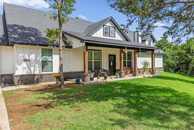 16315 SE 59th St, Choctaw, OK 73020 - back of property with roof with shingles, board and batten siding, a yard, a porch, and brick siding