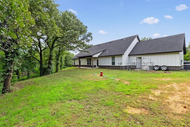 16315 SE 59th St, Choctaw, OK 73020 - rear view of property with a yard, a shingled roof, and board and batten siding