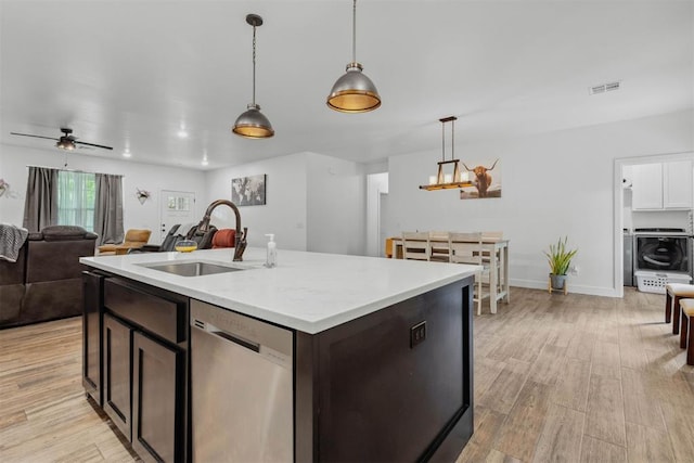 16315 SE 59th St, Choctaw, OK 73020 - kitchen with stainless steel dishwasher, a sink, open floor plan, light countertops, and light wood finished floors