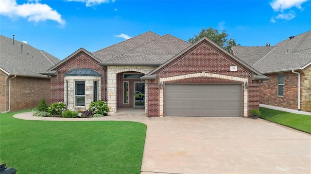 1116 River Birch Dr, Yukon, OK 73099 - french country inspired facade featuring a garage, brick siding, driveway, a front lawn, and a shingled roof