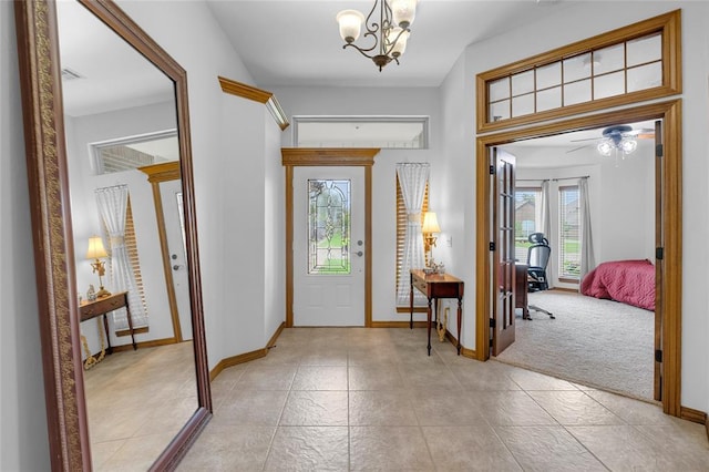 1116 River Birch Dr, Yukon, OK 73099 - entrance foyer featuring a chandelier, baseboards, a ceiling fan, light tile patterned flooring, and light carpet