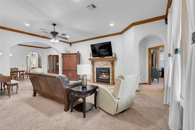 1116 River Birch Dr, Yukon, OK 73099 - living room featuring arched walkways, light carpet, recessed lighting, a stone fireplace, and crown molding