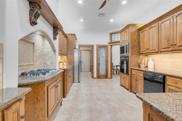 1116 River Birch Dr, Yukon, OK 73099 - kitchen with black appliances, light stone countertops, tasteful backsplash, a ceiling fan, and recessed lighting