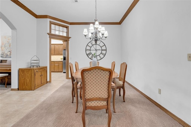 1116 River Birch Dr, Yukon, OK 73099 - dining space with crown molding, arched walkways, a chandelier, and baseboards