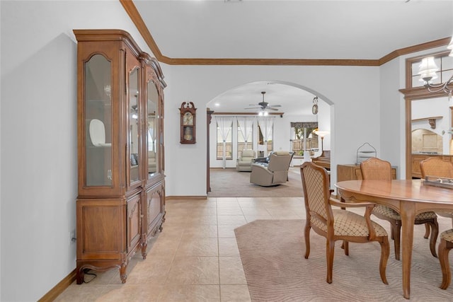 1116 River Birch Dr, Yukon, OK 73099 - dining area featuring arched walkways, baseboards, a ceiling fan, light tile patterned floors, and ornamental molding