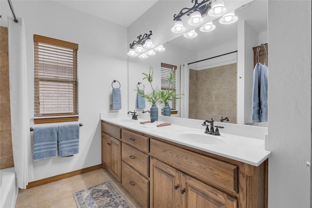 1116 River Birch Dr, Yukon, OK 73099 - bathroom with double vanity, tile patterned flooring, baseboards, and a chandelier