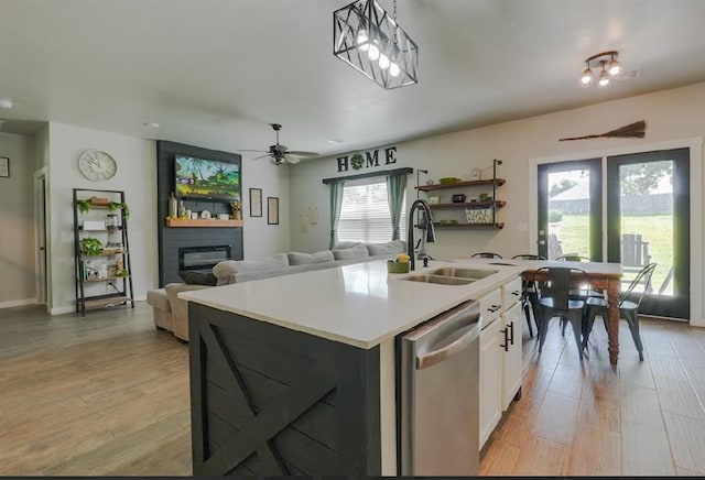 15963 Trail Head Rd, Mcloud, OK 74851 - kitchen with dishwasher, a sink, light countertops, white cabinets, and light wood finished floors