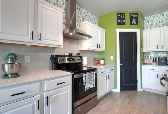 15963 Trail Head Rd, Mcloud, OK 74851 - kitchen featuring wall chimney exhaust hood, electric range, wallpapered walls, and white cabinets