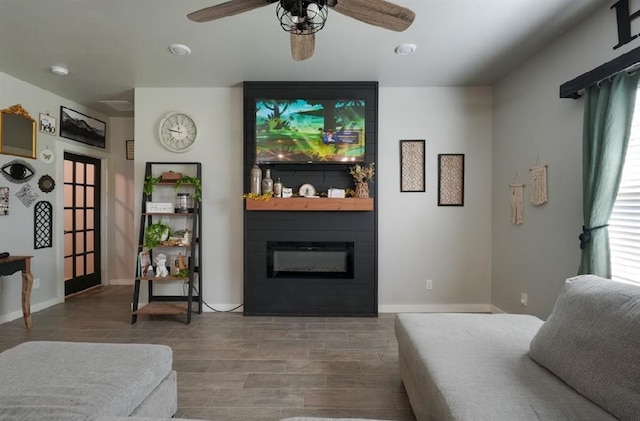 15963 Trail Head Rd, Mcloud, OK 74851 - living area featuring a fireplace, wood finished floors, a ceiling fan, and baseboards