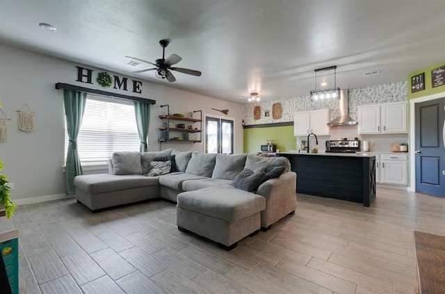 15963 Trail Head Rd, Mcloud, OK 74851 - living area with ceiling fan, light wood-type flooring, and baseboards
