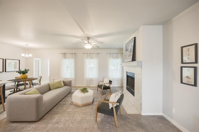 18020 Mounts Farm Rd, Edmond, OK 73012 - living area with a tile fireplace, a chandelier, ceiling fan, baseboards, and carpet floors