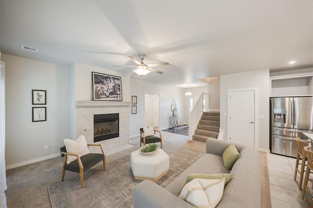 18020 Mounts Farm Rd, Edmond, OK 73012 - living room with a tiled fireplace, stairway, ceiling fan, and baseboards