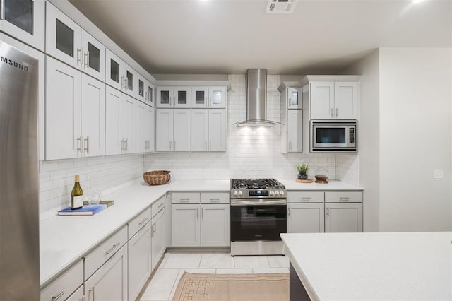 18020 Mounts Farm Rd, Edmond, OK 73012 - kitchen featuring stainless steel appliances, wall chimney range hood, backsplash, and light countertops