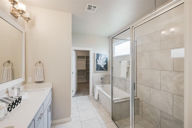 18020 Mounts Farm Rd, Edmond, OK 73012 - bathroom with double vanity, a spacious closet, a tile shower, a garden tub, and baseboards