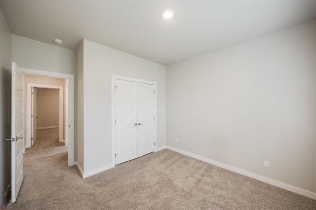 18020 Mounts Farm Rd, Edmond, OK 73012 - unfurnished bedroom featuring light colored carpet, baseboards, a closet, and recessed lighting