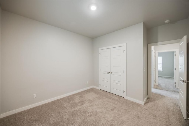 18020 Mounts Farm Rd, Edmond, OK 73012 - unfurnished bedroom with light carpet, baseboards, and a closet