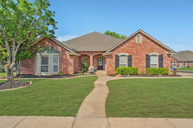 4605 NW 161st St, Edmond, OK 73013 - view of front of house featuring brick siding, a front yard, and roof with shingles