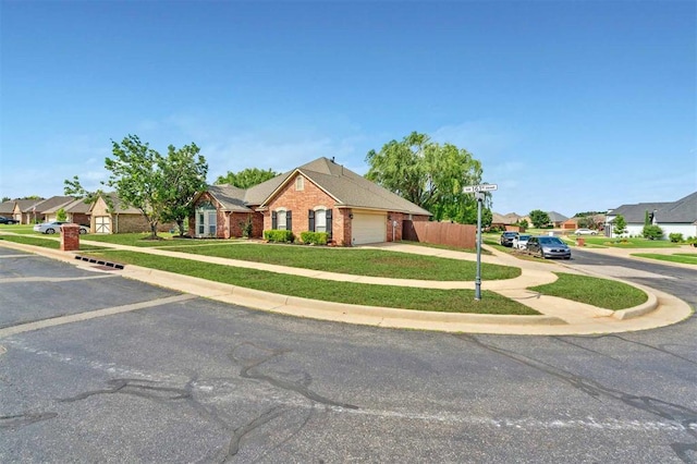 4605 NW 161st St, Edmond, OK 73013 - view of front of home featuring an attached garage, brick siding, a residential view, and driveway