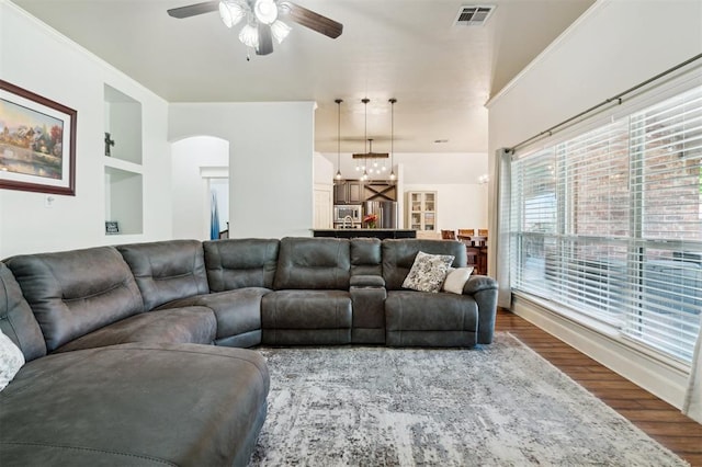4605 NW 161st St, Edmond, OK 73013 - living room with ceiling fan, wood finished floors, arched walkways, and a chandelier