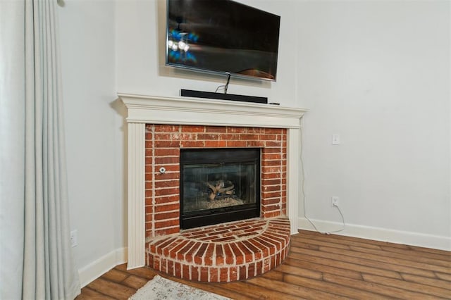 4605 NW 161st St, Edmond, OK 73013 - detailed view of a brick fireplace, wood finished floors, and baseboards