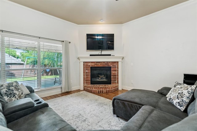 4605 NW 161st St, Edmond, OK 73013 - living room featuring wood finished floors, crown molding, baseboards, and a brick fireplace