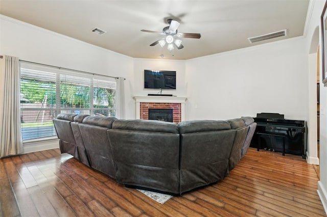 4605 NW 161st St, Edmond, OK 73013 - living area featuring ceiling fan, hardwood / wood-style floors, a brick fireplace, and ornamental molding