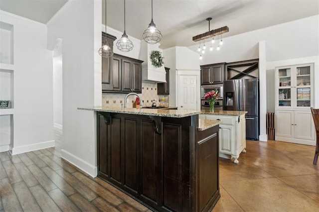 4605 NW 161st St, Edmond, OK 73013 - kitchen with appliances with stainless steel finishes, backsplash, a peninsula, a kitchen bar, and light stone countertops