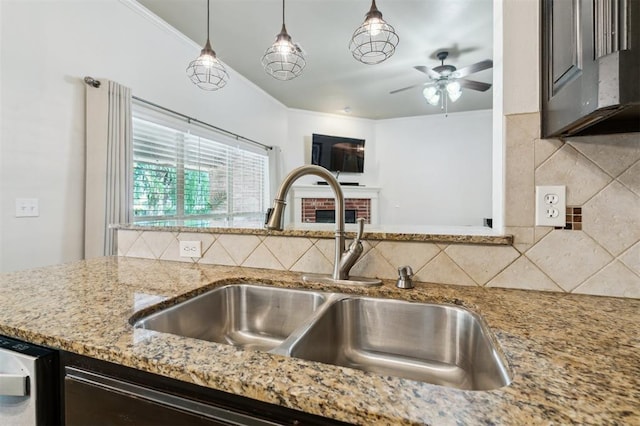 4605 NW 161st St, Edmond, OK 73013 - kitchen with a sink, light stone countertops, ceiling fan, tasteful backsplash, and hanging light fixtures