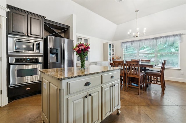 4605 NW 161st St, Edmond, OK 73013 - kitchen with appliances with stainless steel finishes, a chandelier, vaulted ceiling, a center island, and light stone countertops