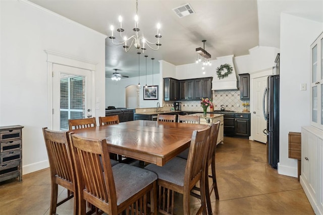 4605 NW 161st St, Edmond, OK 73013 - dining room with a chandelier, finished concrete flooring, a ceiling fan, and baseboards