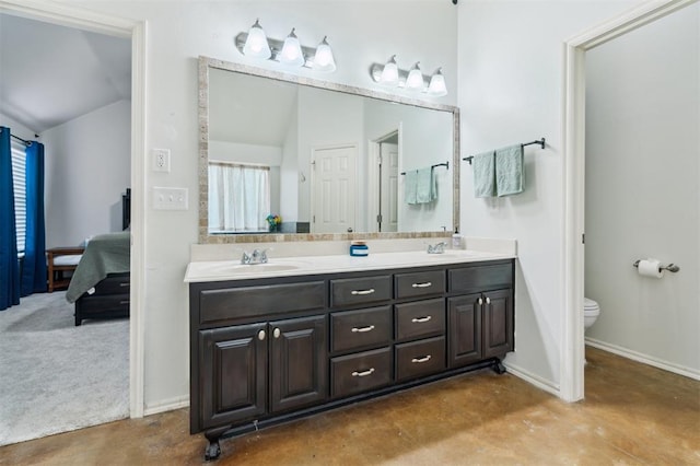4605 NW 161st St, Edmond, OK 73013 - full bath with double vanity, vaulted ceiling, connected bathroom, toilet, and finished concrete flooring