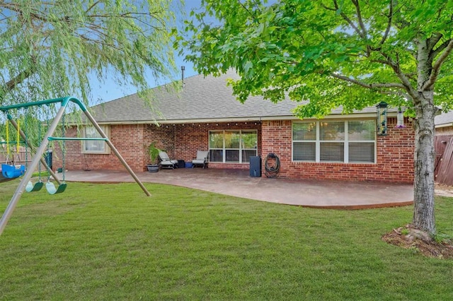 4605 NW 161st St, Edmond, OK 73013 - back of property with a playground, a patio, brick siding, and a shingled roof