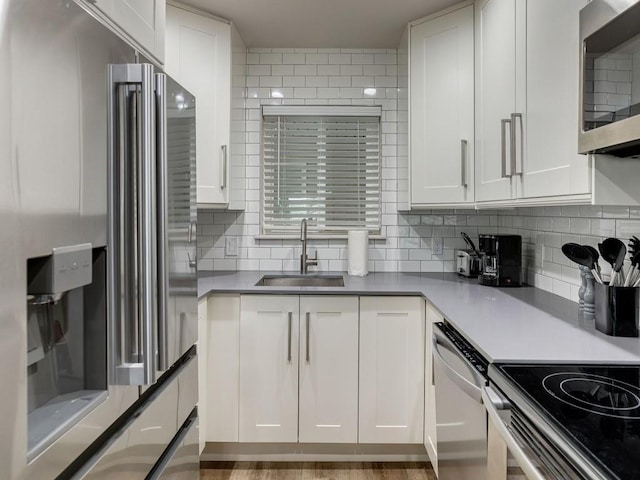 1110 Sherwood Ln Unit 223, Nichols Hills, OK 73116 - kitchen featuring appliances with stainless steel finishes, white cabinetry, and backsplash