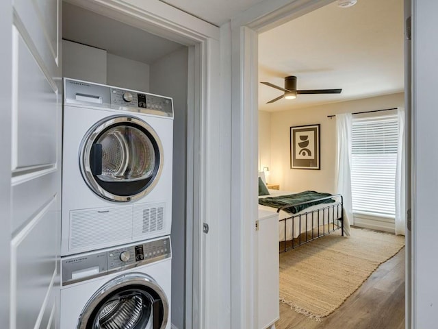 1110 Sherwood Ln Unit 223, Nichols Hills, OK 73116 - laundry area with stacked washer and clothes dryer, wood finished floors, and a ceiling fan