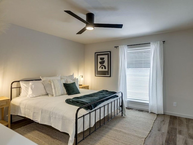 1110 Sherwood Ln Unit 223, Nichols Hills, OK 73116 - bedroom featuring wood finished floors and a ceiling fan