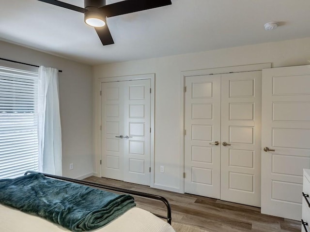 1110 Sherwood Ln Unit 223, Nichols Hills, OK 73116 - bedroom featuring wood finished floors and ceiling fan