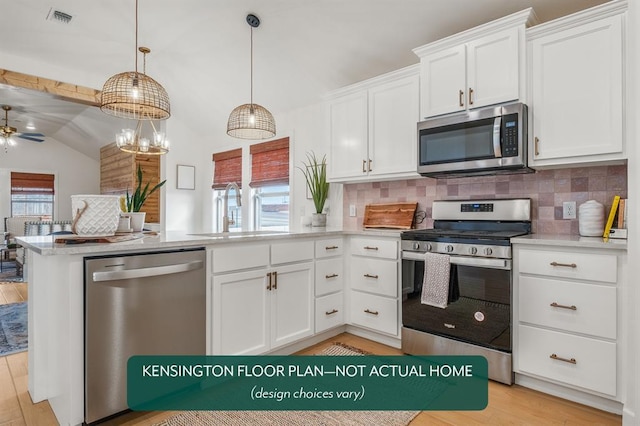 12808 NW 4th St, Yukon, OK 73099 - kitchen featuring appliances with stainless steel finishes, a sink, vaulted ceiling, a peninsula, and tasteful backsplash