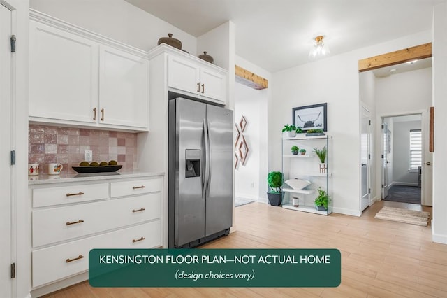 12808 NW 4th St, Yukon, OK 73099 - kitchen featuring stainless steel fridge with ice dispenser, tasteful backsplash, white cabinets, light wood finished floors, and baseboards