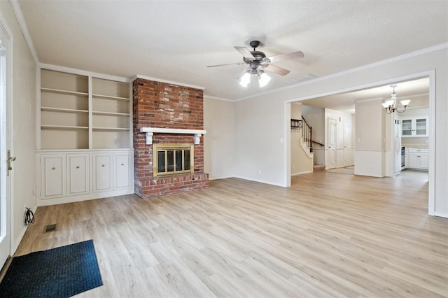3119 W Wilshire Blvd, Oklahoma City, OK 73116 - unfurnished living room featuring wood finished floors, a chandelier, ceiling fan, ornamental molding, and stairs