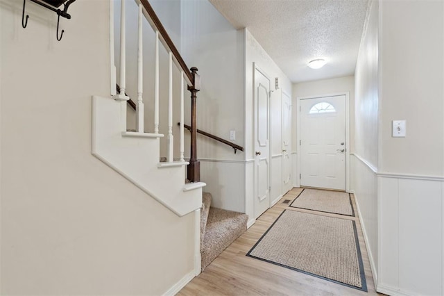 3119 W Wilshire Blvd, Oklahoma City, OK 73116 - foyer entrance with a textured ceiling, wood finished floors, and stairs