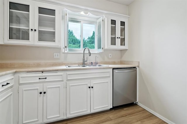 3119 W Wilshire Blvd, Oklahoma City, OK 73116 - kitchen featuring dishwasher, a sink, white cabinets, glass insert cabinets, and light wood-type flooring